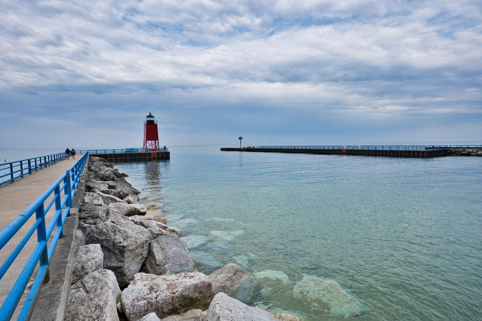 Beautiful view of Charlevoix South Pier Lighthouse with tranquil Lake Michigan waters.